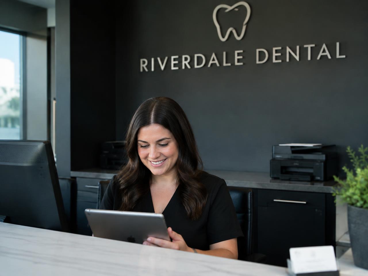 Front desk team member using a tablet at a modern office
